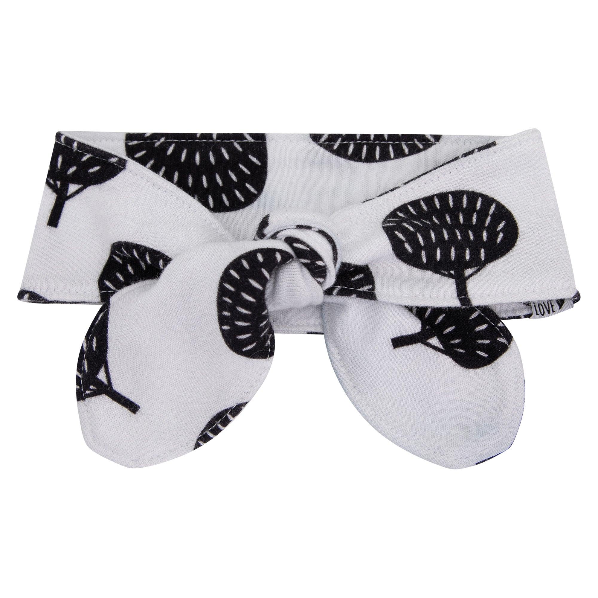 Laço de cabelo infantil regulável em algodão, com estampa exclusiva de árvores boho minimalistas, em tons neutros sobre fundo branco. Acessório sofisticado e confortável para bebês e crianças pequenas.